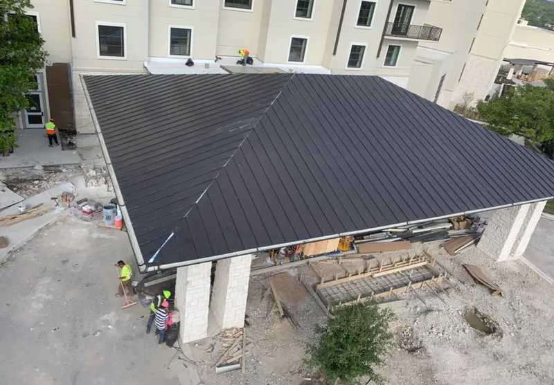 Metal roofing installation team working on a commercial building in Bailey's Crossroads
